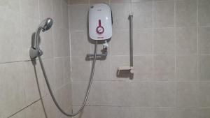 a shower in a bathroom with a shower head at HWKl in Kuala Lumpur