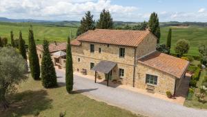 an aerial view of a stone house with trees at Villa Campriano by VacaVilla in Pienza