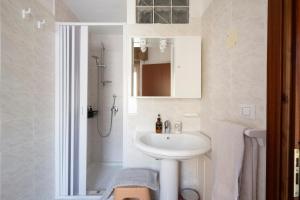 a white bathroom with a sink and a shower at B&B Cardedu in Cardedu +33 photos