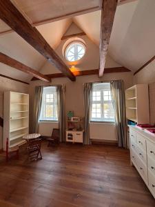 a large living room with two windows and a table at Charlottenhof in Wangels