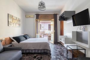 a living room with a bed and a tv at B&B Cardedu in Cardedu