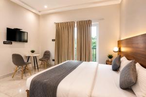 a hotel room with a large bed and a table at Sanctuary Boutique Hotel in Bhīm Tāl +17 photos