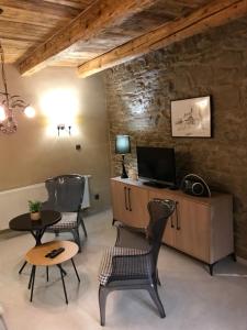 a living room with two chairs and a television at Apartmány Za Zvončekom in Vydrná