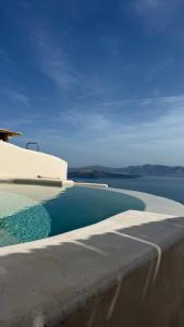 a swimming pool with a view of the water at Akrorama private villas and suites in Akrotiri