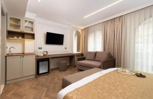 a hotel room with a bed and a desk and a chair at Stern Hotel Karaköy-Special Class in Istanbul