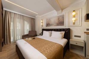 a hotel room with a bed and a chair at Stern Hotel Karaköy-Special Class in Istanbul