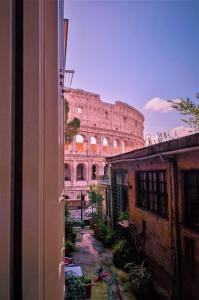 a view of the coliseum from a window of a building at Tre R Colosseo in Rome