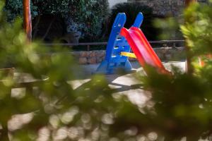 a playground with two blue and red plastic slides at Villa Kimothoe with Private Pool, only 20 min to Elafonissi Beach in AmigdhalokeFálion
