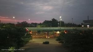 a car parked in a parking lot under a bridge at Hotel Pride Executive in Satara +4 photos