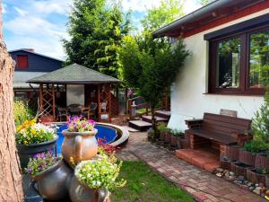 a backyard with a bench and a gazebo at Ferienhaus an den Eichen in Aschersleben