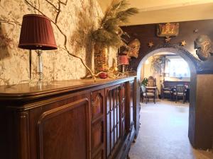 a room with a large wooden cabinet with a lamp on it at Rezydencja Jagiellońska in Sanok