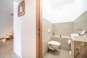 a bathroom with a toilet and a sink at Cosy House in Sillingy +16 photos