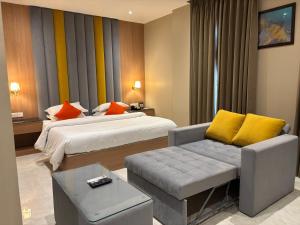 a hotel room with a bed and a couch at Regenta Inn Jaipur, Adarsh Nagar in Jaipur +56 photos
