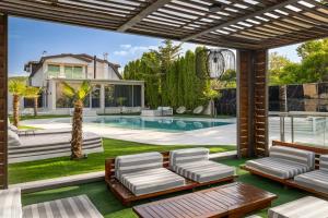 a backyard with a swimming pool and a house at Aura Villas Skopje in Skopje