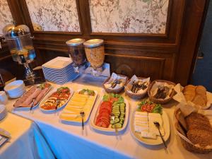 a table with several plates of food on it at Rezydencja Jagiellońska in Sanok