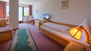 a hotel room with a bed and a desk at Landgasthof Zum Schwanen in Hornberg