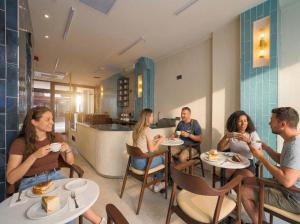a group of people sitting at tables in a restaurant at Stern Hotel Karaköy-Special Class in Istanbul