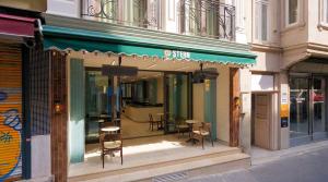 a store front with chairs and a table in the window at Stern Hotel Karaköy-Special Class in Istanbul