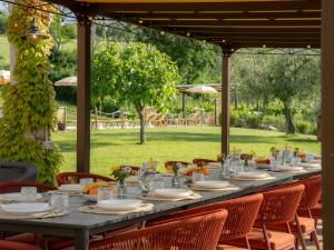 a long table with plates and glasses on it at Casalantico in Corinaldo