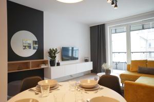 a living room with a table and a couch at Space Apartments Szczecin in Szczecin