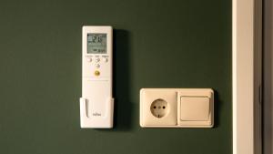 a wall with an alarm clock and a thermometer at Restaurant & Hotel De Jaeger in Ruurlo