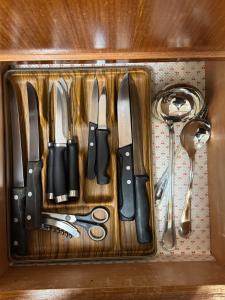 a drawer filled with knives and other kitchen utensils at Foppolo GH in Foppolo