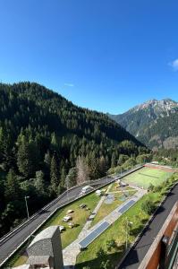 a view of a mountain with a road and a tennis court at Foppolo GH in Foppolo