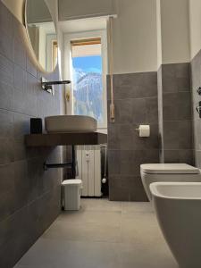 a bathroom with a sink and a toilet and a window at Foppolo GH in Foppolo +25 photos