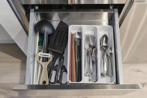 a utensil drawer with utensils in it at Cavatina in Sapporo