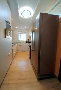 a kitchen with a large stainless steel refrigerator at JKIA Transit Hub in Syokimau