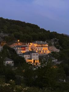 a large house on top of a hill at night at Pirrion Villas in Ano Pedina