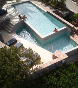 two people swimming in a swimming pool at Paralos Irini Mare in Agia Galini +140 photos