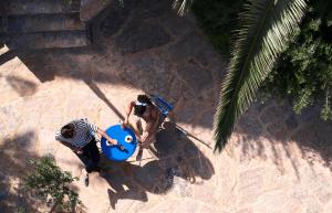 an overhead view of two men playing with a frisbee at Paralos Irini Mare in Agia Galini