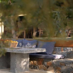 a stone table with a bowl of fruit on it at Paralos Irini Mare in Agia Galini