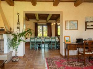 a dining room with a table and blue chairs at Casalantico in Corinaldo