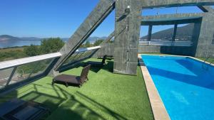 a house with a swimming pool and a chair at Hotel Playamar Spa in Laredo