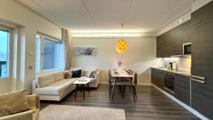 a living room with a couch and a table at Red Apartment 19 in Tahkovuori