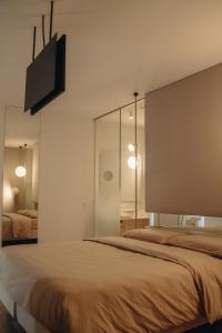a bedroom with a bed and a tv on the wall at Mafrica House in Aosta