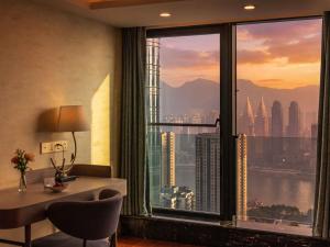 a room with a desk and a window with a view at Mercure Chongqing Downtown in Chongqing