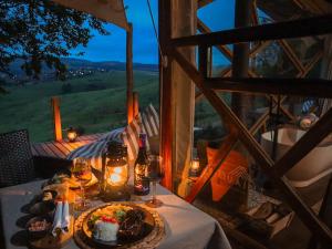 a table with a plate of food and glasses of wine at Quaint Luxury Villas in Graskop
