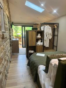 a room with two beds and a wall with a mirror at The Sanctuary Ashover in Chesterfield