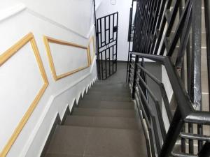 a staircase with black and white railings in a building at P M Serviced Apartments in Lagos