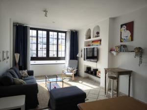 a living room with a couch and a table at Apartamento playero Privado WiFi- MorroJable in Morro del Jable