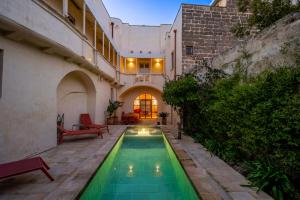 a swimming pool in the courtyard of a building at Palazzo Saetta in Nardò