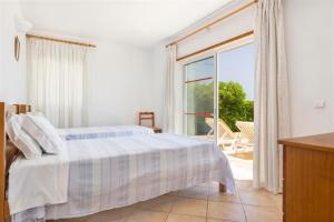 a bedroom with a bed and a sliding glass door at Casa Campo in Loulé +35 photos