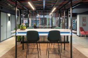 a conference room with a table and four chairs at Silk Mill Edinburgh in Edinburgh
