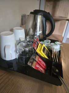 a black tray with coffee and other items on a table at Rooms by the Oak in Baginton +6 photos