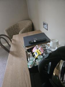 a table in a room with a desk with a keyboard at Rooms by the Oak in Baginton