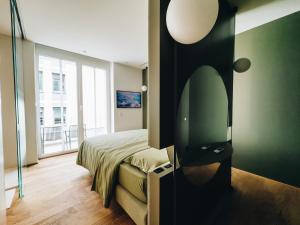 a bedroom with a bed and a mirror on the wall at Mafrica House in Aosta