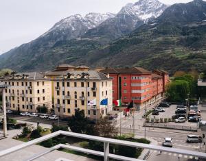 a city with buildings and mountains in the background at Mafrica House in Aosta